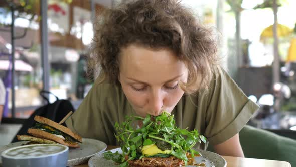 Joyful Starving Young Woman Eats Her Vegan Toast Without Hands