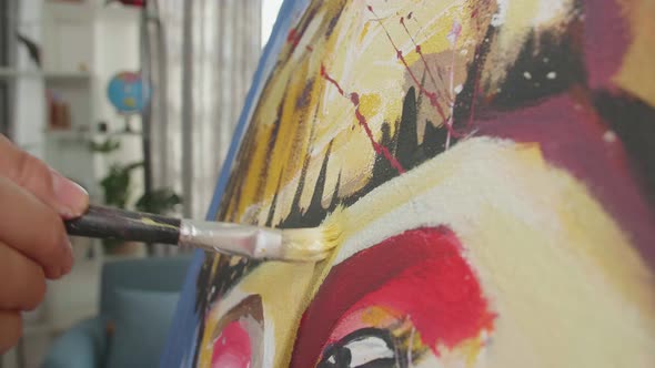 Close Up Of A Hand Holding Paintbrush Mixed Colour And Painting A Girl's Nose On The Canvas