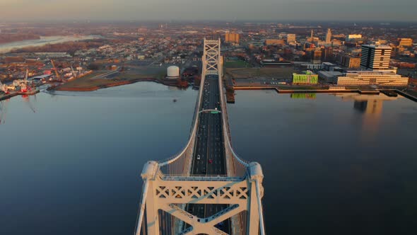 Aerial view of cars and traffic driving along the Ben Franklin Bridge from overhead during a warm su