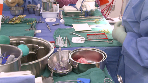 Surgical Technician Working At Instrument Table