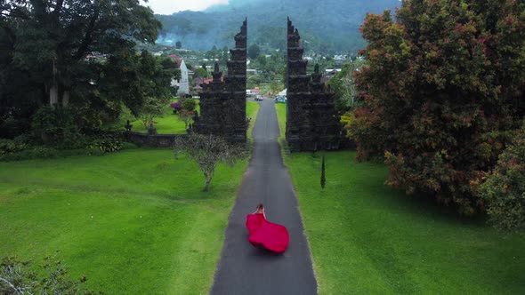 Woman Runs to Balinese Gates in Dress Slowmotion