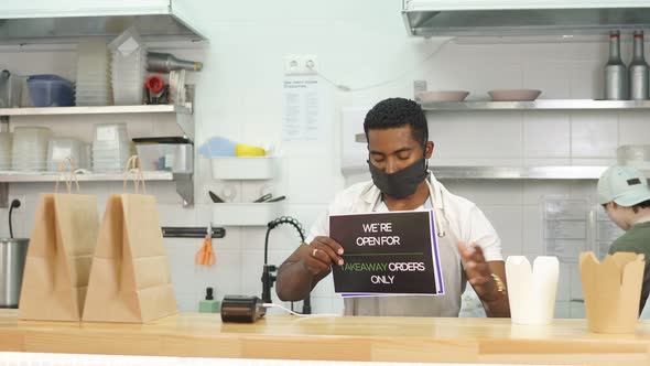 Confident Cafe Worker in Mask at Work