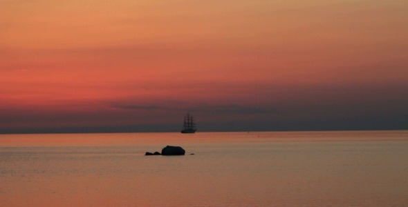 Silhouette of Vintage Ship in the Sea at Sunset