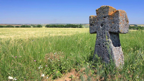 Ancient Tomb Cross in the Green Field