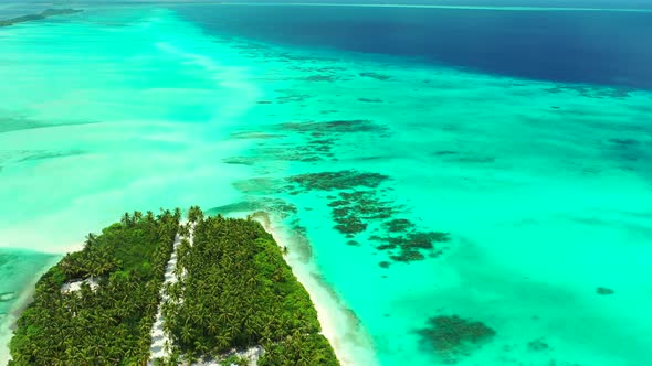 Daytime fly over clean view of a paradise sunny white sand beach and blue water background