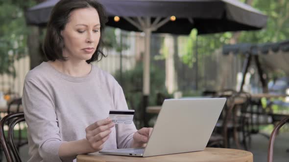 Successful Online Shopping By Old Woman Sitting Outdoor