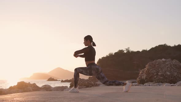 Sporty Woman Jogger Stretching on Beach with Sea View