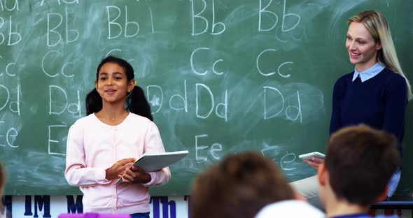 Schoolgirl taking lesson of her classmates