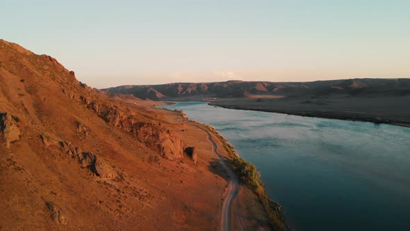 Drone Shot of River and Mountains at Sunset in Kazakhstan