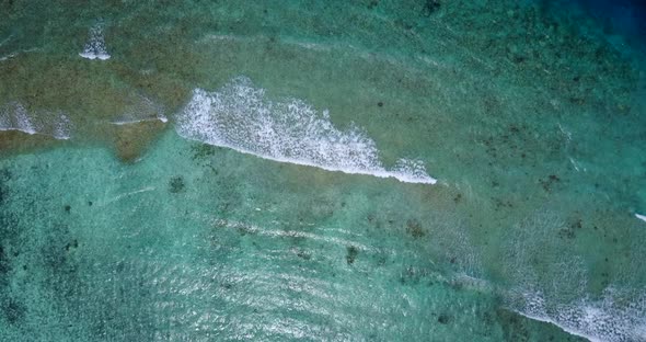 Beautiful birds eye clean view of a white sand paradise beach and aqua blue water background in best