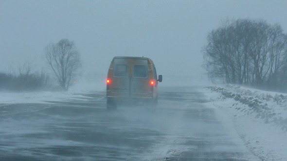 Cars On Winter Road At Blizzard alt