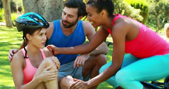 Friends looking after injured woman