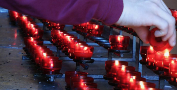 Wish Praying Red Candles in Church