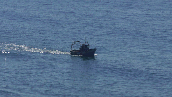 Fishing Boat Floating on the Ocean Waves alt