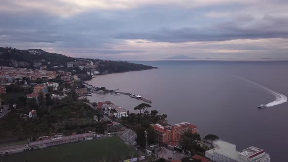 The coastal town of Sorrento in Italy, a beautiful landscape of houses near the bay of Naples at sun