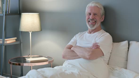 Happy Old Man Smiling at Camera in Bed 