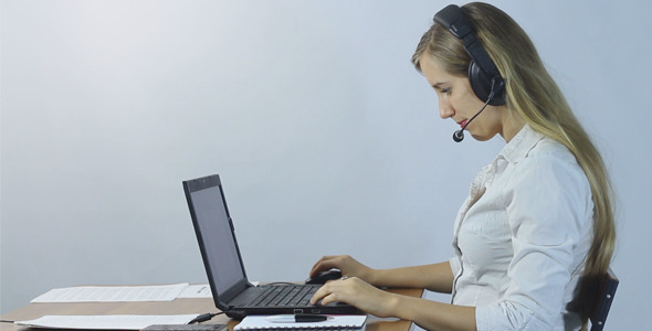 Call Center Operator Working With Laptop and Talk