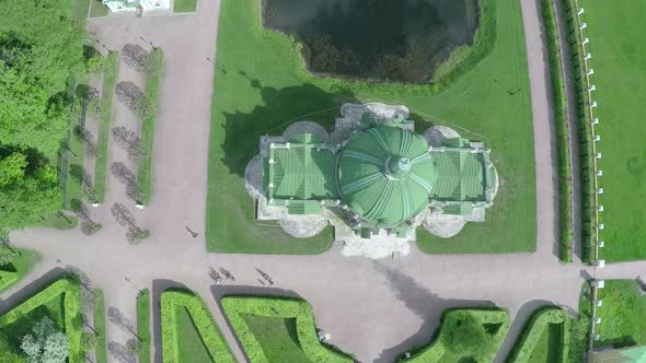 Flying over ancient building and pond in Tsaritsyno