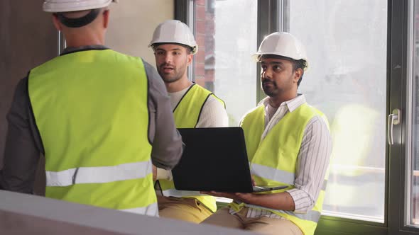 Male Architects in Helmets Meeting at Office