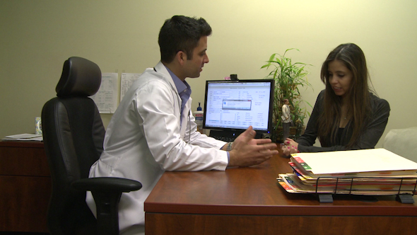 Male Doctor Consults With Female Patient