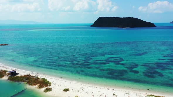 Aerial scenery of tropical lagoon beach holiday by blue green water with white sandy background of a