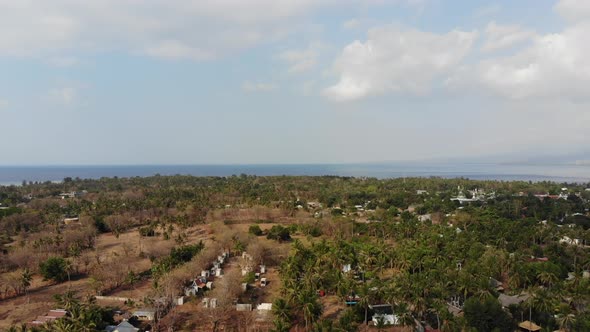 Drone shot of Gili Air island, Indonesia, on a hot, sunny day.