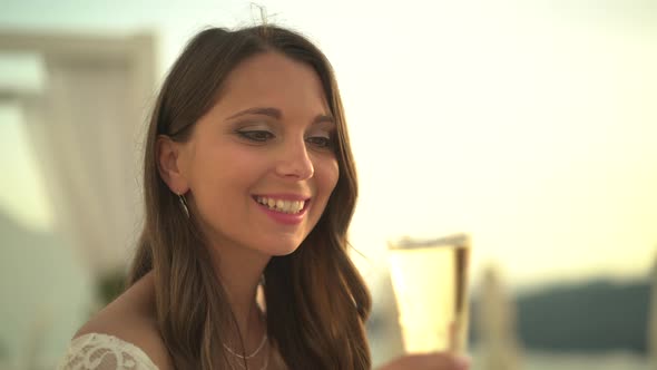 Woman Drinking Champange at Sunset