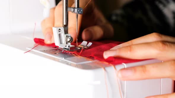 The Girl Starts Sewing on a Sewing Machine, .