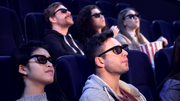 People Watch 3D Film at the Movie Theater