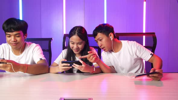 Team Of Asian Gamers Playing In Competitive Video Games On A Cyber Games Tournament By Mobile Phone