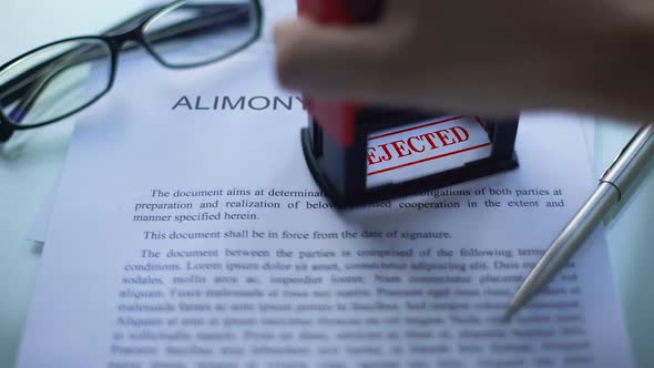 Alimony Agreement Rejected, Officials Hand Stamping Seal on Business Document