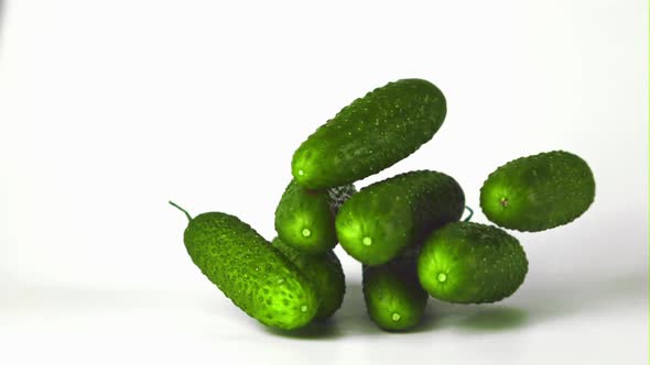 Super Slow Motion Fresh Cucumbers Fall on the Table