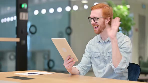 Professional Young Redhead Man Doing Video Call on Tablet