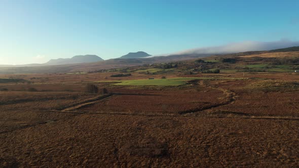 Aerial view of green and brown countryside in Wales on a frosty winter mornin