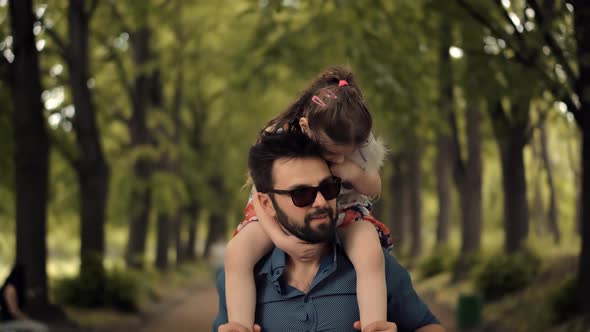 Cute Little Kid Having Fun In Park. Carefree Dad With Preschool Daughter Enjoy Activity Together.