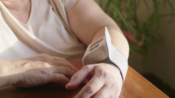 Close-up View of Self Measurement Blood Pressure Using Finger Pressing Digital Sphygmomanometer