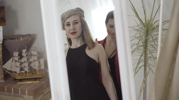 Reflection of Happy Caucasian Young Woman Looking in Mirror and Smiling As Tailor Taking