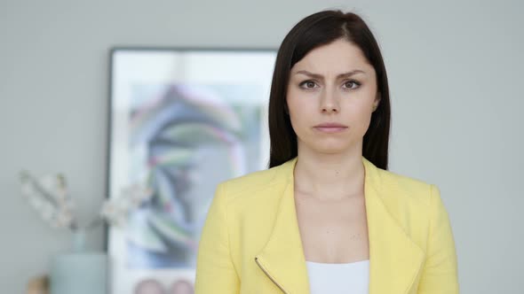 Portrait of Sad Young Woman Looking at Camera