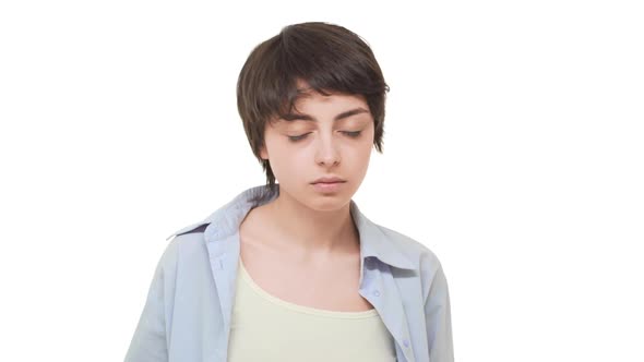 Strict Tired Caucasian Female with Short Haircut Staring at Camera and Shaking Head in Disapproval