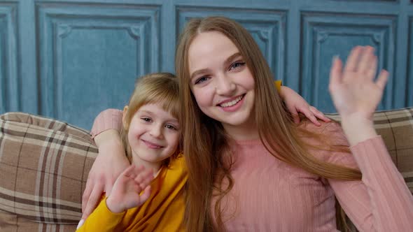 Child Kid Daughter with Mother Embracing Waving Hands to Camera Doing Hello Welcome or Bye Gesture