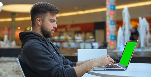 Man Typing On The Notebook With Green Screen