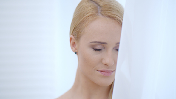 Attractive Happy Woman Behind White Cloth