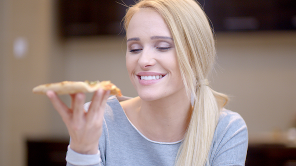 Attractive Woman Enjoying A Slice Of Pizza 2