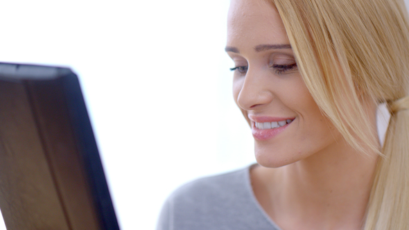 Happy Blond Girl Using Her Tablet Computer