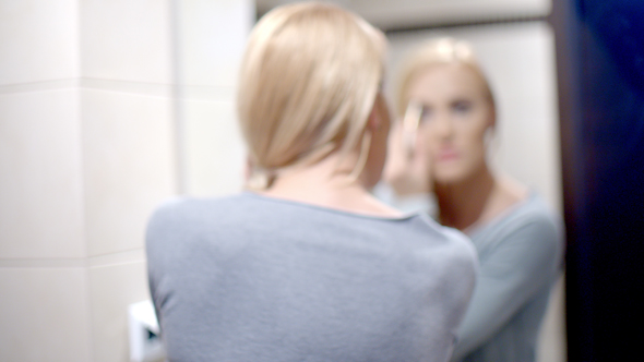 Happy Woman Putting Make Up In Front A Mirror 3