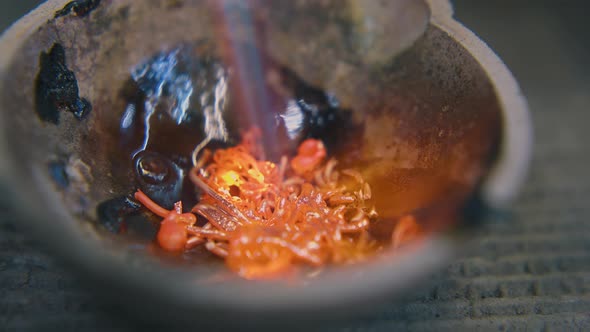 Melting Old Gold in Cup with Hot Gas Burner on Table Closeup