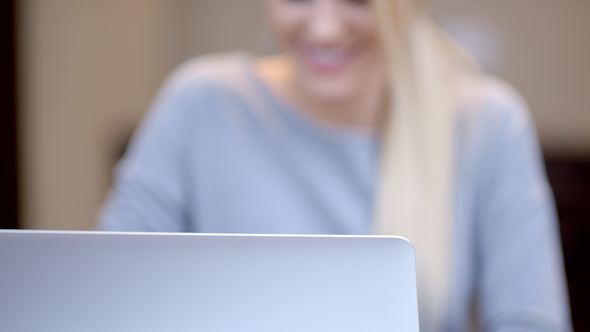 Smiling Young Woman Working On A Laptop 3