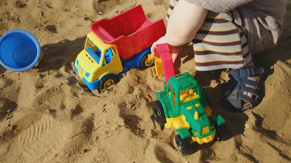 Little Boy Playing with Plastic Sandbox Toys Outdoors