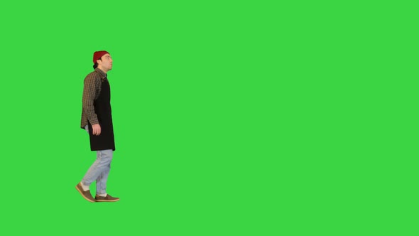 Handyman Walks After Workday Wiping His Hands on a Green Screen Chroma Key