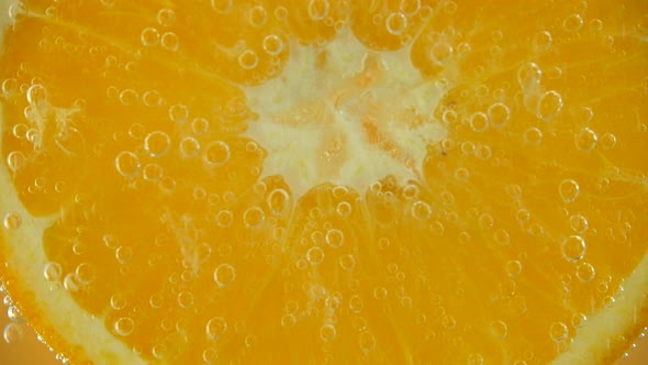 Air bubbles around an orange slice.